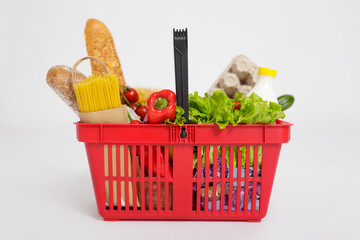 shopping basket full of healthy food isolated over white