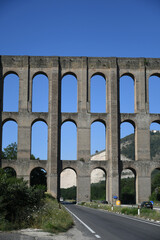 Fototapeta na wymiar Caserta province, Italy. The arched aqueduct built in the 18th century to bring water to the gardens of the royal palace of Caserta. 