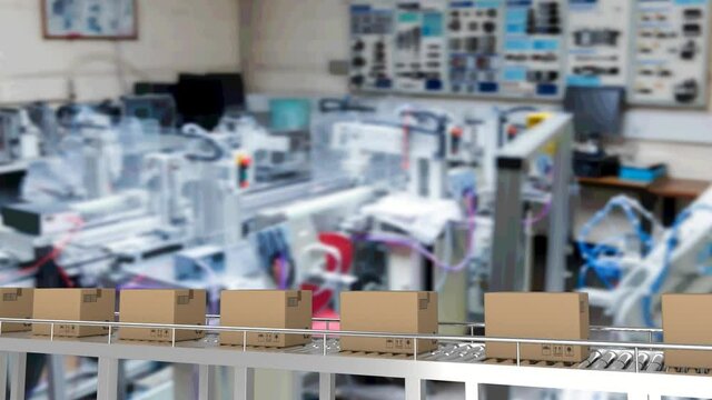 Multiple delivery boxes on conveyor belt against office in background