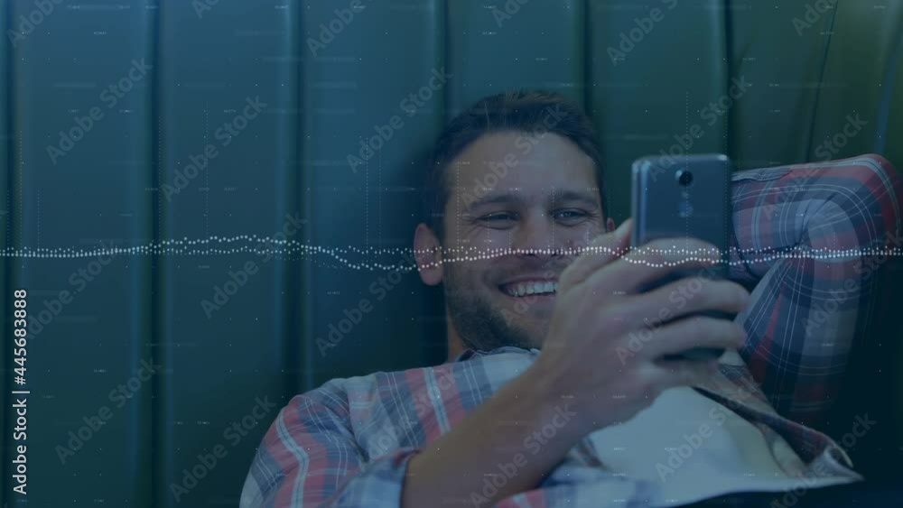Poster statistical graphs against caucasian man smiling while using smartphone
