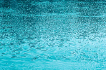 Blue water background. The calm surface of the sea. Ocean. Natural abstract background. Film grain and noise.