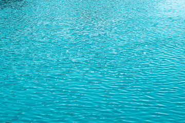 Blue water background. The calm surface of the sea. Ocean. Natural abstract background. Film grain and noise.