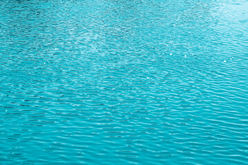 Blue water background. The calm surface of the sea. Ocean. Natural abstract background. Film grain and noise.