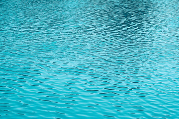 Blue water background. The calm surface of the sea. Ocean. Natural abstract background. Film grain and noise.