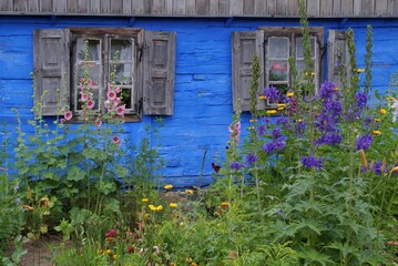 casement window in an old, blue painted wooden country house in Mazovia, Poland 