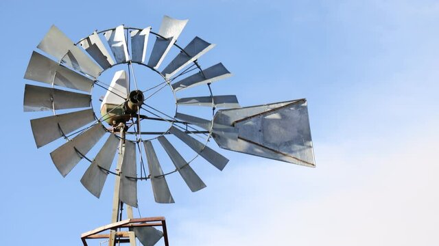 Camera Raises Above Old Metal Vintage Windmill with Blue Sky - Shallow Depth of Field