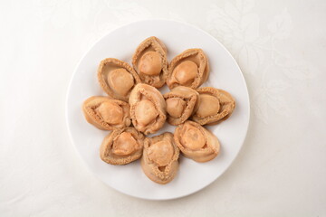 raw 10 head fresh abalone in slice and whole piece in white background asian seafood halal sashimi menu