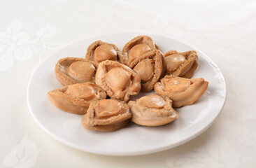 raw 10 head fresh abalone in slice and whole piece in white background asian seafood halal sashimi menu