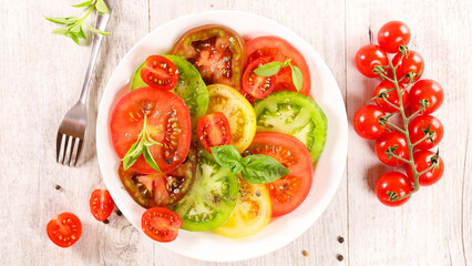 Fototapeta na wymiar tomato salad slices with fresh basil
