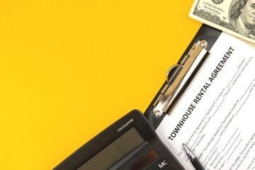 Townhouse rental agreement form. Office desktop with calculator, pen and money. Top view photo and...