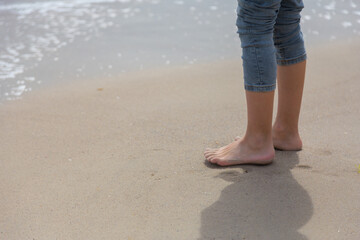 Feet on the sand near the sea, beach