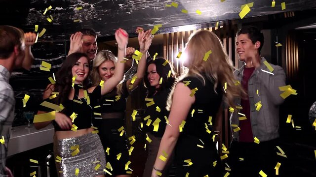 Animation of confetti falling over happy group of friends dancing at party