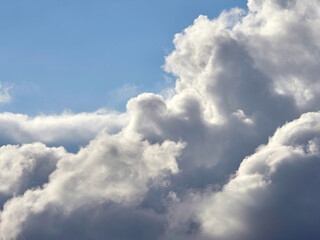 Dark and white clouds on a background of blue sky