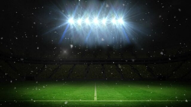 Animation of snow falling over empty sports stadium with spotlights