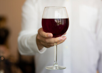 Man hand glass of red wine for health benefits
