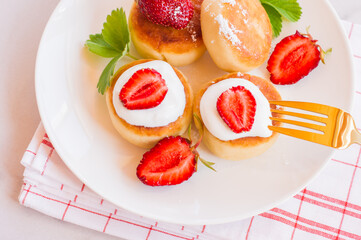 Cottage cheese pancakes, syrniki, curd fritters with strawberry. Gourmet Breakfast. White background