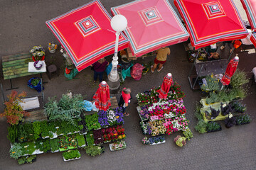 colorful flower market with red umbrellas in centre  Zagreb