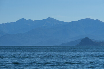 Lake maggiore during a sunny spring day near the Borromean islands and the town of Stresa, Italy - June 2021