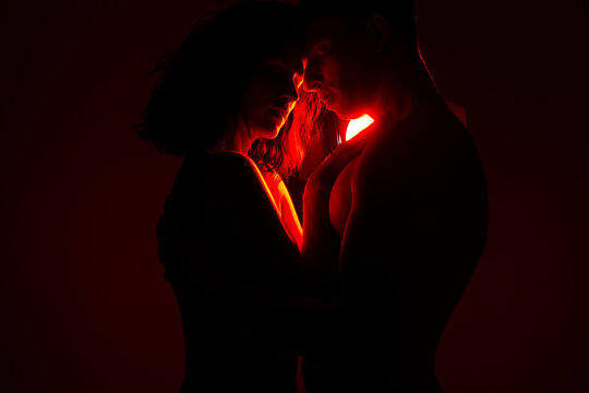 Sexy couple love. Dark background. Studio. Erotic. Man and woman posing studio. Love photo. 