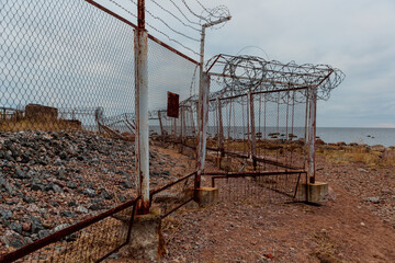 barbed wire on the fence in cloudy weather