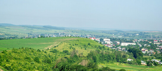 Small town Rohatyn in Ukraine among fields and hills on a summer day