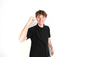 Happy teenager celebrating with his fist raised. portrait, white background, 18-20 years old. White european guy.