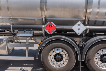 Fototapeta na wymiar Danger labels for flammable (fire) and toxic (skull) liquids on a tanker with dangerous goods.