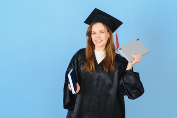 Woman graduate student wearing graduation hat and gown, on blue background