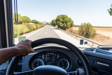 View that a truck driver has from his workplace, with one hand gripping the steering wheel, the...