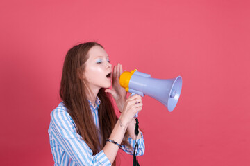 Little kid girl 13 years old in blue dress isolated on pink background whispering in megaphone