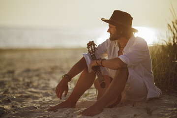 Man With Ukulele During Summer Beach Vacation Near the Sea