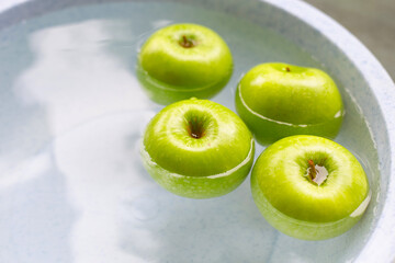 Washing fresh green apples in the water