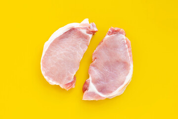Fresh pork on yellow background.