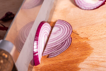 Slicing red onion into half rings - close-up