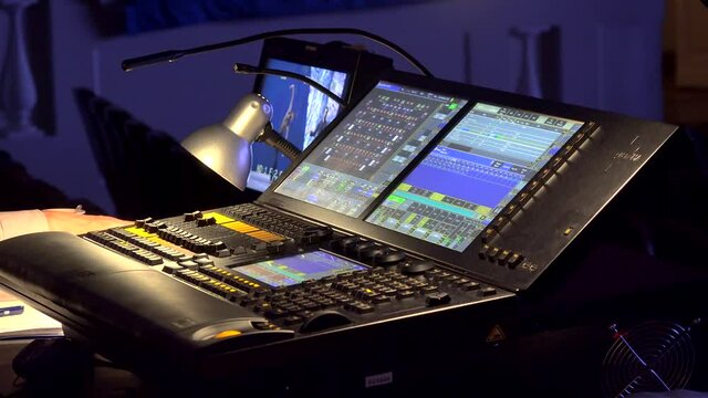 Work of the lighting engineer behind a lighting console.