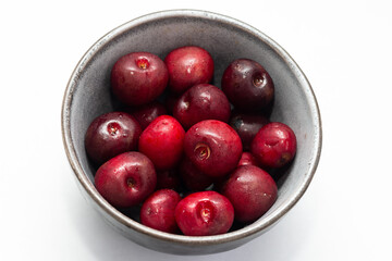 Fresh ripe cherries in a cup on a white background. Dessert. Vegetarian breakfast. Healthy eating.