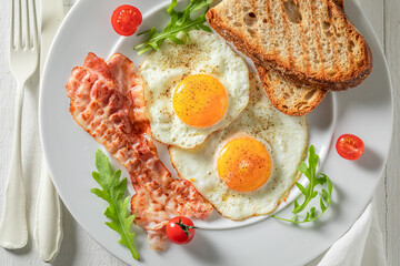 Tasty breakfast with eggs, bacon and tomatoes. Classic breakfast.