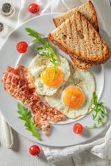Homemade breakfast with toast, eggs and bacon. British breakfast.