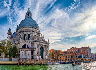 Fototapeta na wymiar Beautiful view of iconic basilica di Santa Maria della Salute or St Mary of Health by waterfront of Grand Canal, Venice, Italy. Famous landmark.