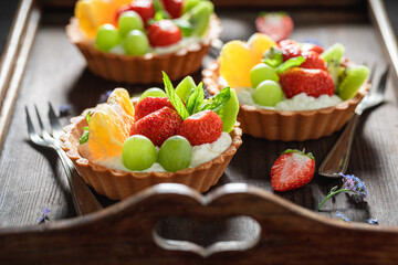 Delicious mini tart with strawberries and grapes. Simple fruit dessert.
