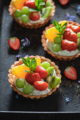 Delicious mini tart with various fruits. Sweet summer dessert.