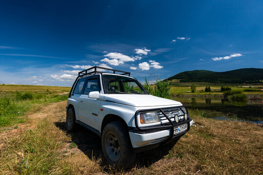 Miercurea Ciuc, Romania- 17 July 2021: Parking Suzuki Vitara in very good condition near a small pond.