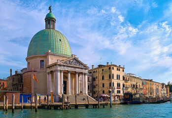 Naklejka premium Beautiful church of San Simeone Piccolo on Grand Canal, Venice, Italy, daylight, blue sky, soft clouds, landmark of waterway, UNESCO world heritage