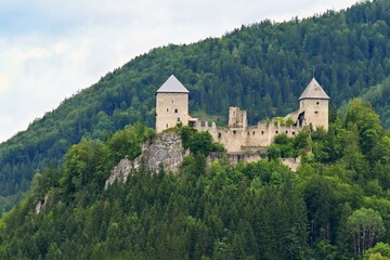 Fototapeta na wymiar Castle ruins Gallenstein. Beautiful old castle in the Austrian Alps with forest and rock on the hill.