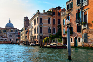 Fototapeta na wymiar Beautiful view of Grand Canal and church of St Jerome or San Geremia, Venice, Italy. Famous city, romantic charm, day, sunshine, blue sky