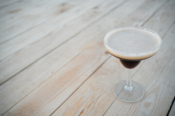 luxury espresso martini cocktail drink in elegant glass on wooden background
