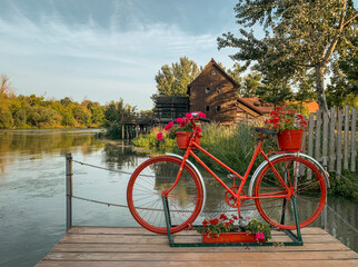 Vintage red bicycle with old watermill on river Maly Dunaj. Jelka, Slovakia - obrazy, fototapety, plakaty