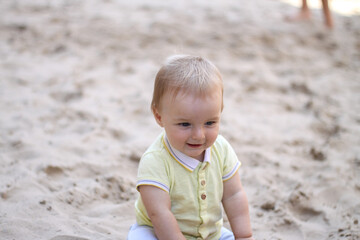 little boy playing in the sand. baby plays with sand. Summer rest. Sun, sea, beach, sand. Rest, childhood.