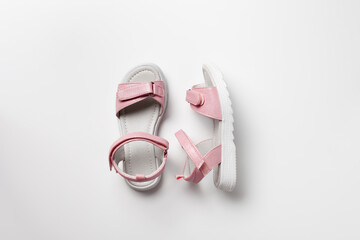 Pink insulated sandals. Children's pink sandals with white soles and Velcro fasteners isolated on a white background. Fashionable children's shoes for children. 