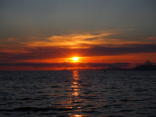 A dark sunset on a calm sea      
